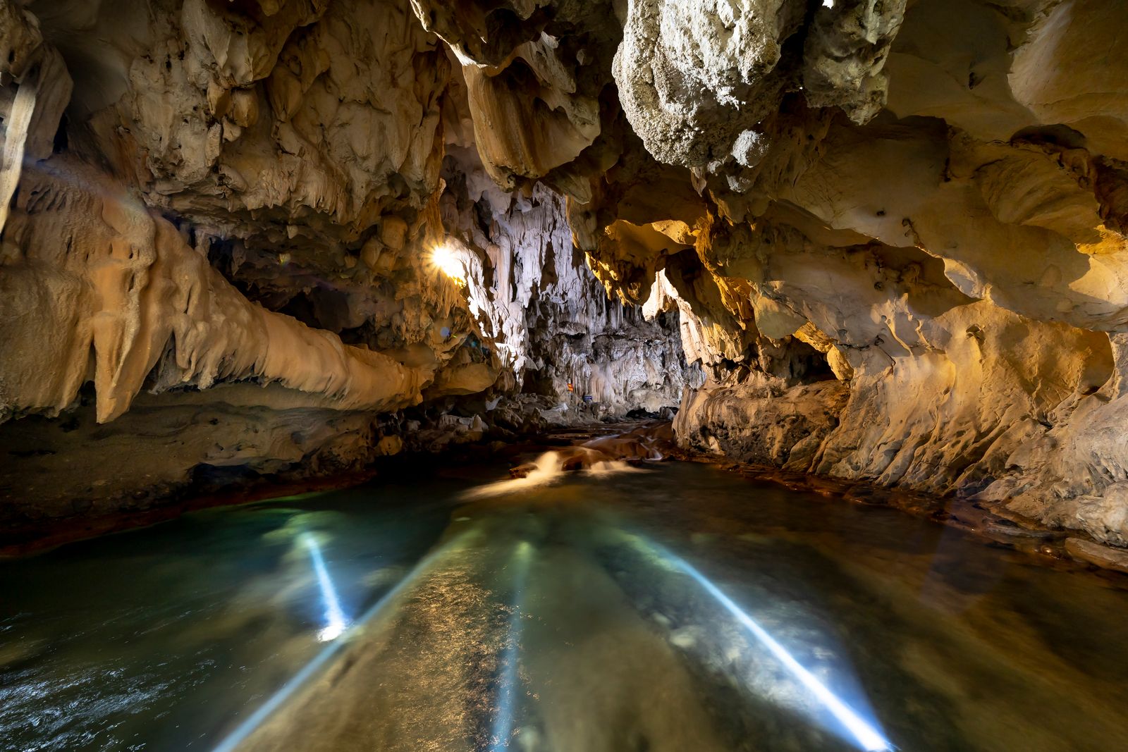 A limestone cave chamber with an underground stream
